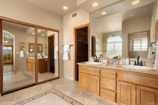 bathroom with ceiling fan and vanity