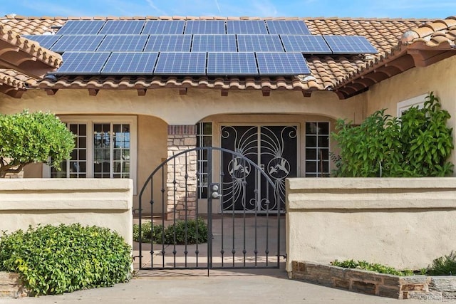 view of gate with solar panels