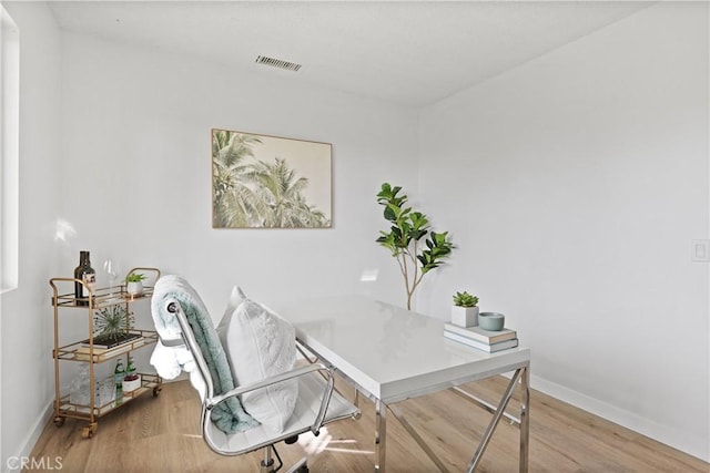 home office with wood-type flooring