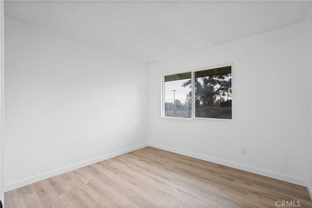 spare room with light hardwood / wood-style floors