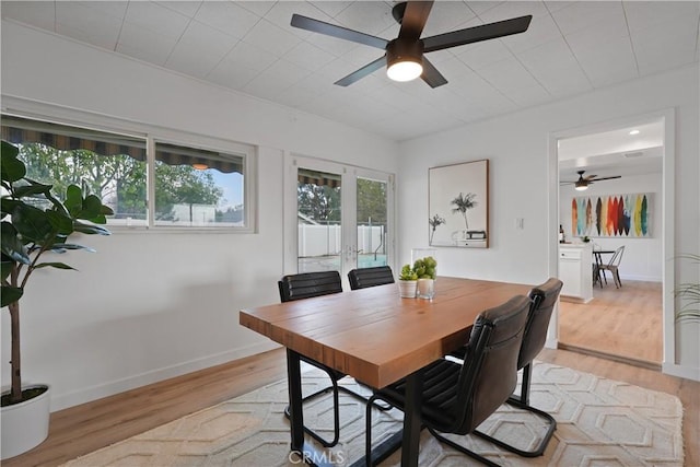 dining space featuring light wood-type flooring and ceiling fan