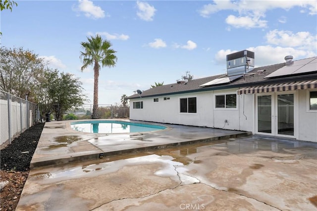 view of swimming pool with french doors, a patio, and central AC unit