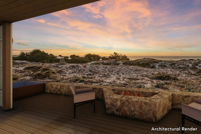 deck at dusk featuring a water view