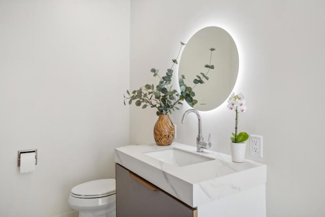 bathroom featuring toilet and vanity