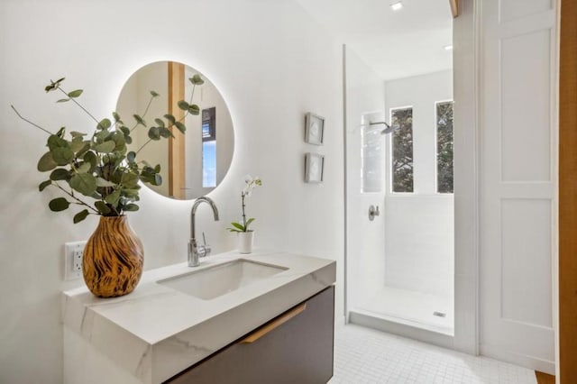 bathroom featuring walk in shower and vanity