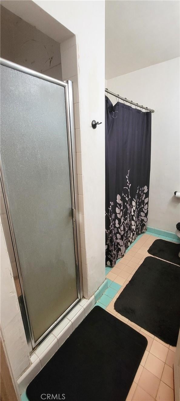 bathroom featuring a shower and tile patterned flooring