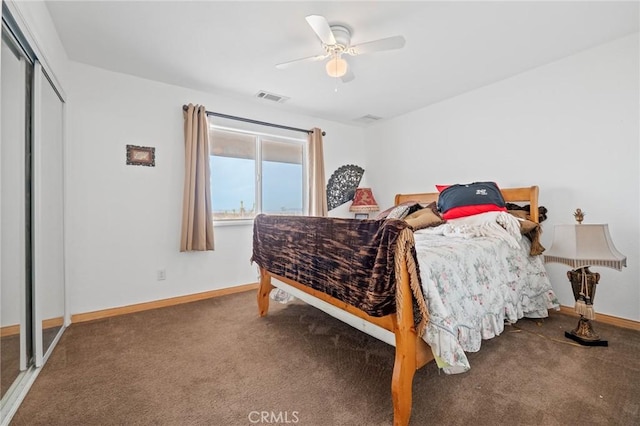 carpeted bedroom with ceiling fan and a closet