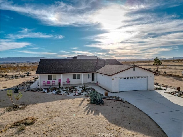 ranch-style home featuring a mountain view and a garage