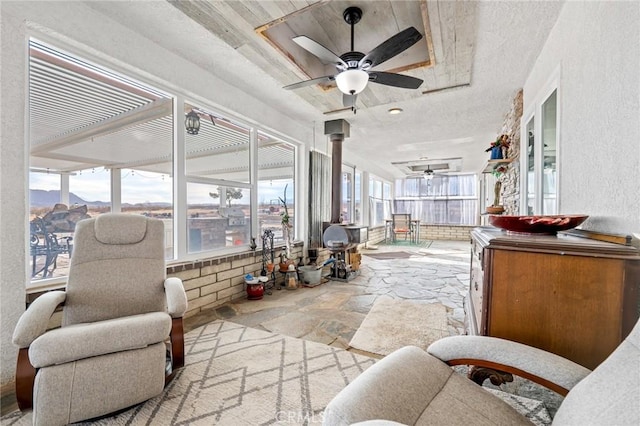 sunroom / solarium featuring ceiling fan