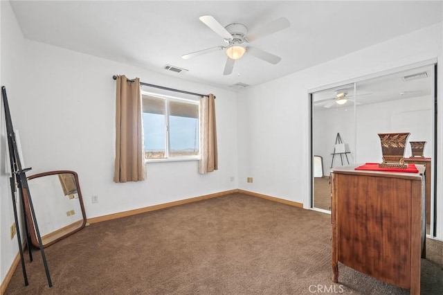 bedroom featuring ceiling fan, a closet, and dark colored carpet