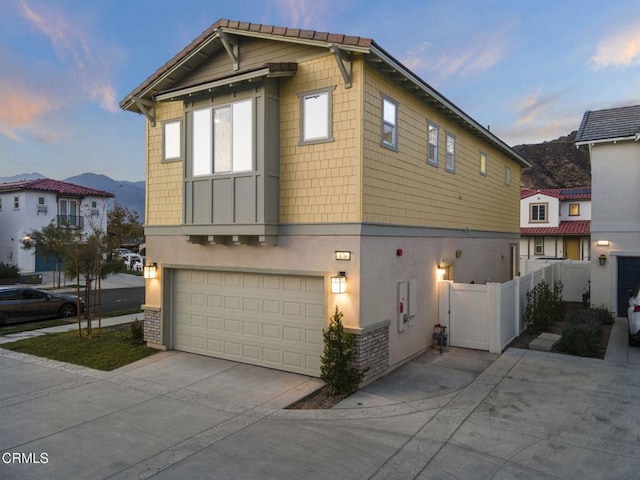 view of front facade with a mountain view and a garage