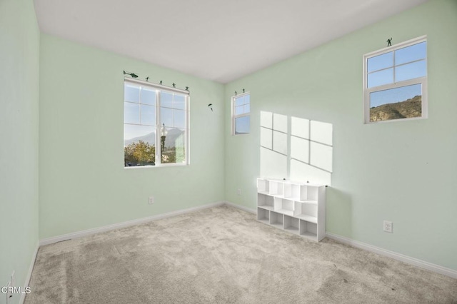 carpeted empty room featuring plenty of natural light