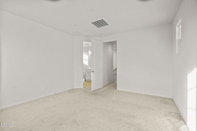 spare room with light colored carpet