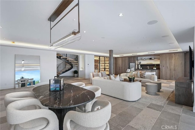 living room with plenty of natural light and a tray ceiling