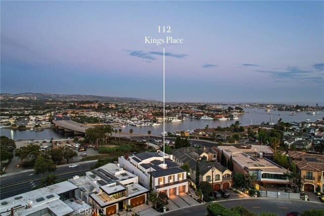 aerial view at dusk with a water view