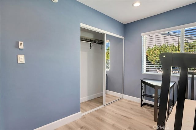 bedroom featuring light wood-type flooring and a closet