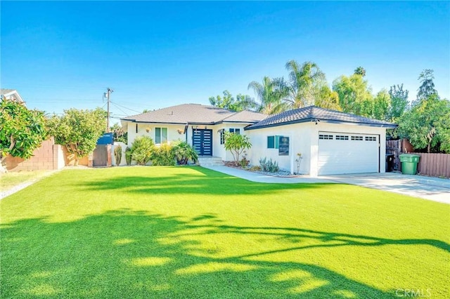 view of front of house featuring a front yard and a garage