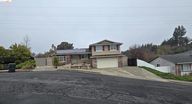 view of front of house with solar panels and a garage