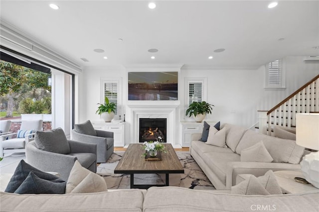 living room featuring light wood-type flooring and crown molding