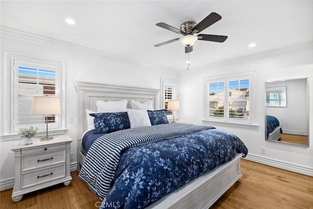 bedroom with ceiling fan, crown molding, and light hardwood / wood-style floors