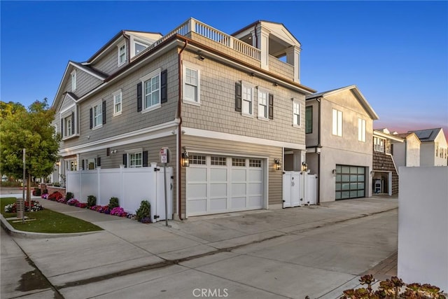 view of property with a balcony and a garage