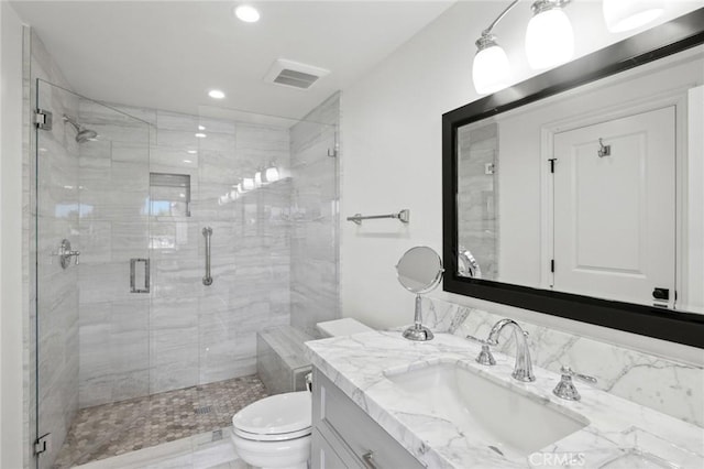 bathroom with vanity, an enclosed shower, and toilet