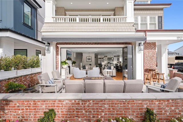 view of patio with a grill and a balcony