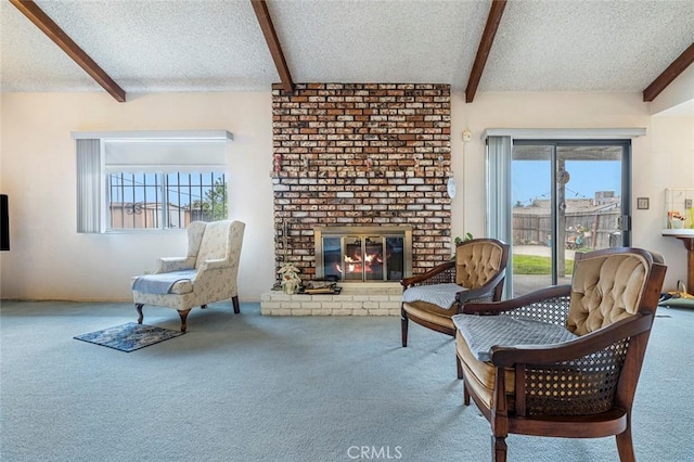 living area with carpet flooring, a textured ceiling, and a brick fireplace