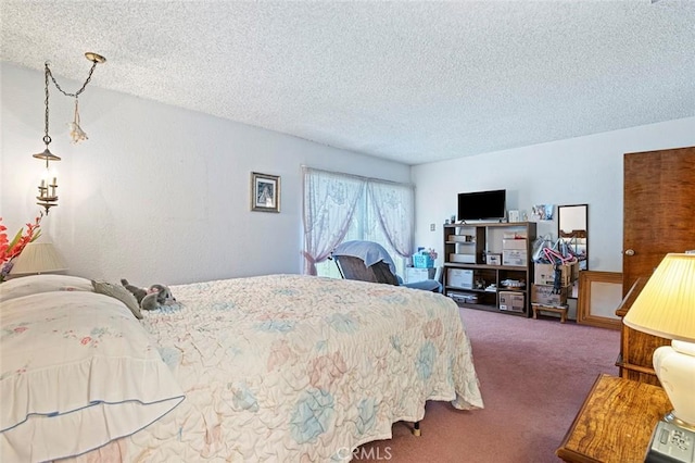 carpeted bedroom featuring a textured ceiling