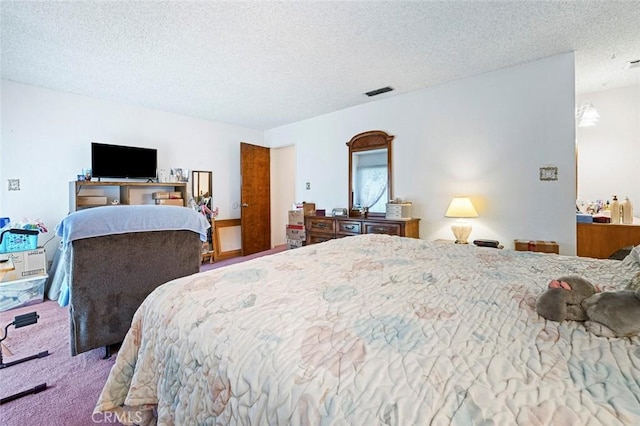 bedroom with carpet and a textured ceiling