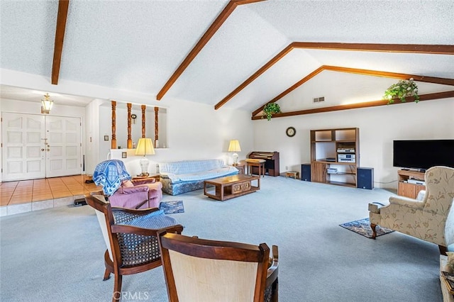 carpeted living room featuring french doors, vaulted ceiling with beams, and a textured ceiling