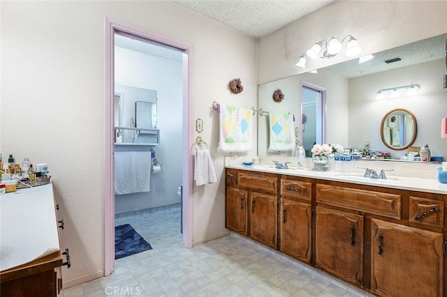 bathroom with vanity and a textured ceiling