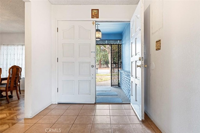 foyer with tile patterned flooring and a textured ceiling