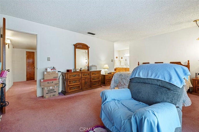 bedroom with carpet and a textured ceiling