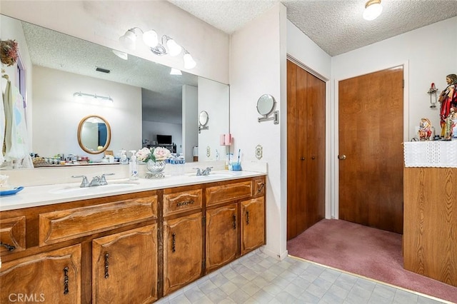 bathroom with vanity and a textured ceiling