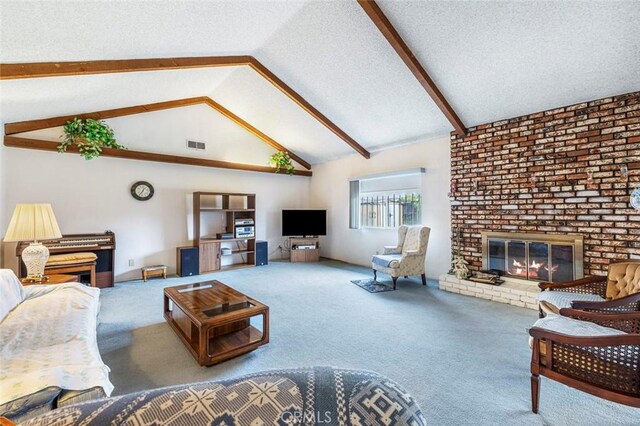 carpeted living room featuring vaulted ceiling with beams, a fireplace, and a textured ceiling