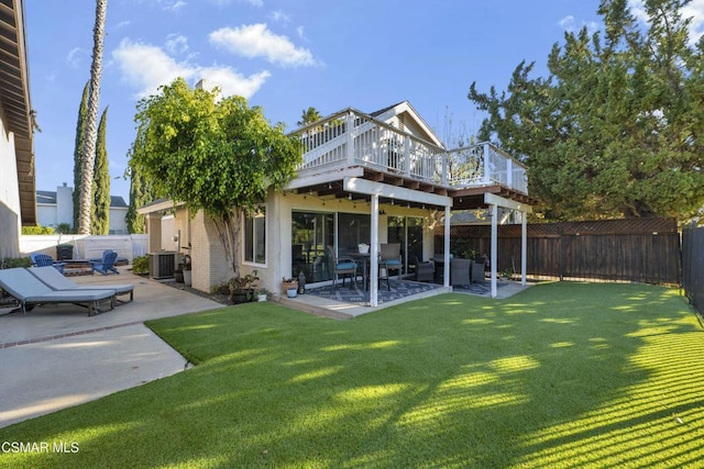 rear view of property featuring a deck, central AC unit, outdoor lounge area, a lawn, and a patio area