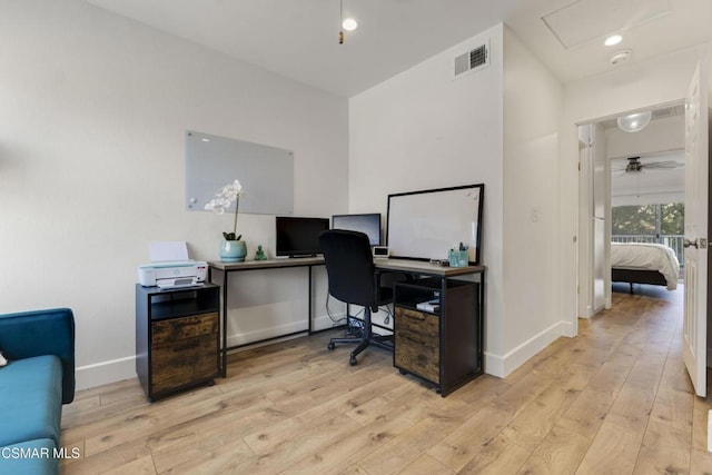 home office featuring ceiling fan and light hardwood / wood-style flooring