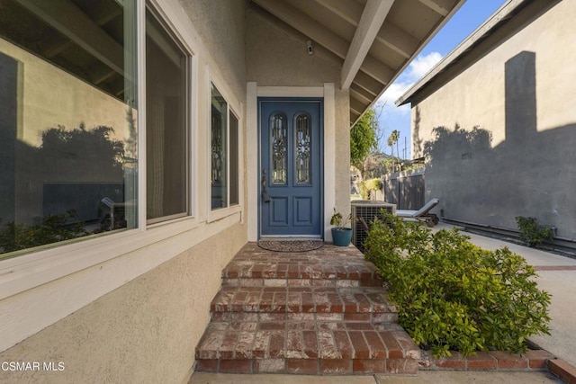 entrance to property featuring central AC