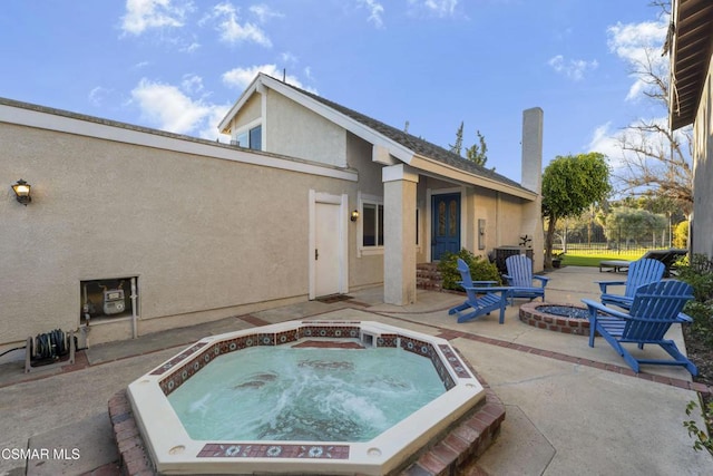 view of pool with a patio, an in ground hot tub, an outdoor fire pit, and central AC unit