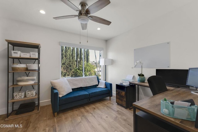 home office with ceiling fan and light hardwood / wood-style floors