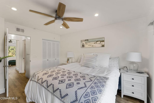 bedroom with a closet, ceiling fan, and dark hardwood / wood-style flooring