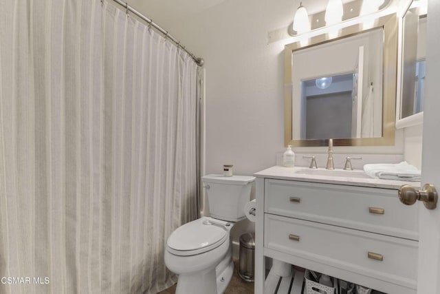 bathroom featuring toilet, vanity, and a shower with curtain