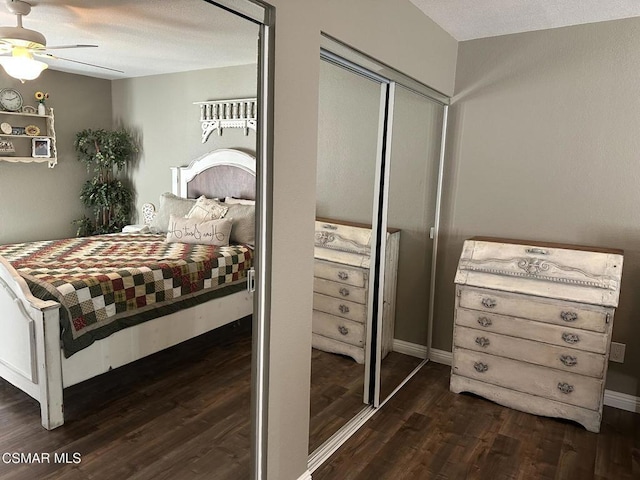 bedroom featuring a textured ceiling, ceiling fan, a closet, and dark hardwood / wood-style floors