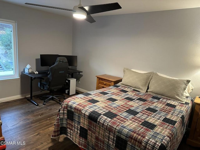 bedroom with dark hardwood / wood-style floors and ceiling fan