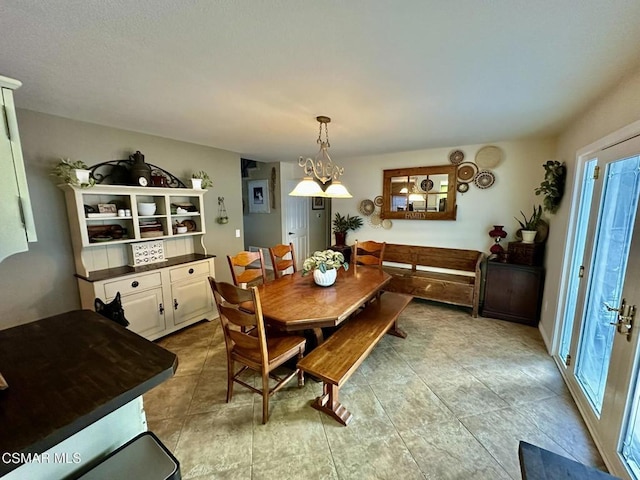 dining room featuring plenty of natural light and an inviting chandelier