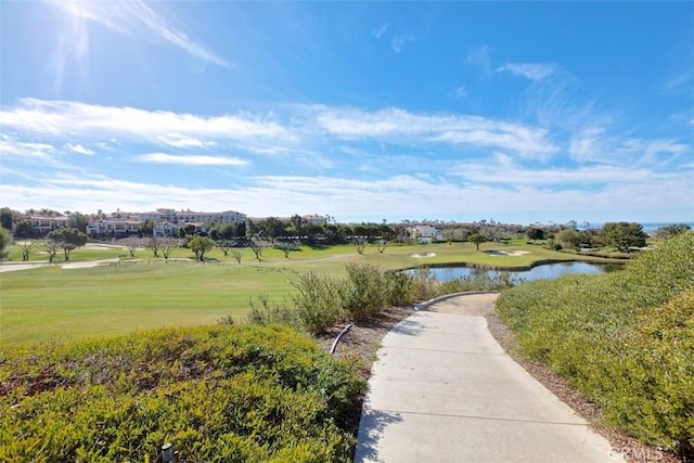 view of community with a water view and a yard