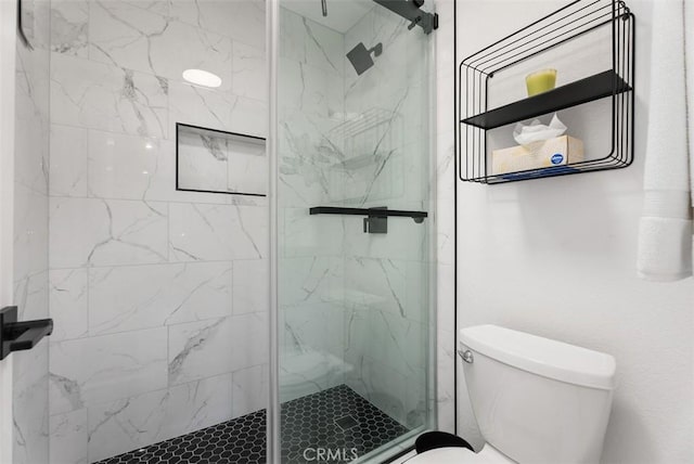 bathroom featuring an enclosed shower and toilet