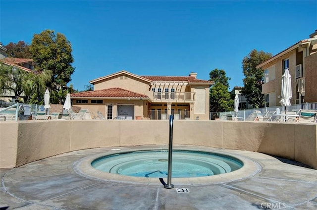 view of swimming pool with a community hot tub