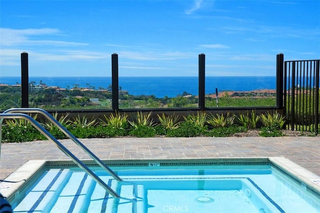 view of swimming pool with a water view